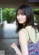 A young woman in a colorful dress posing for a picture.