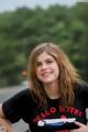 A young woman in a black shirt is posing for a picture.