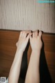 A person's hands on a wooden surface. 