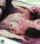 A woman laying in a bathtub covered in water.